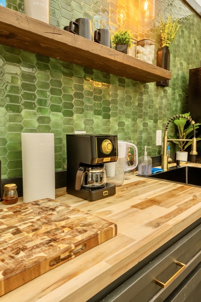 Dome kitchenette with green picket-tile backsplash and butcher-block counters